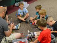 Six children and instructor playing with Legos