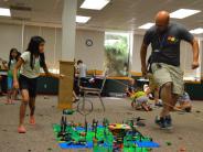 Instructor and children playing with Legos