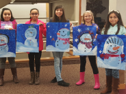 Youth showing their paintings of snowmen
