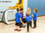 Children and coach playing soccer