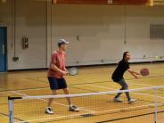 Two people playing pickleball