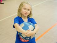 Child holding a soccer ball at Start Smart Soccer