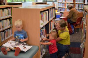 Image of family browsing for books in library